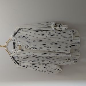 Large cream blouse with black dots and lines.